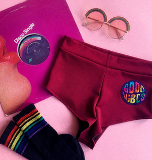 Open image in slideshow, Highwaist Cheeky Shorts in Stretch Lycra with &quot;Good Vibes&quot; Patch
